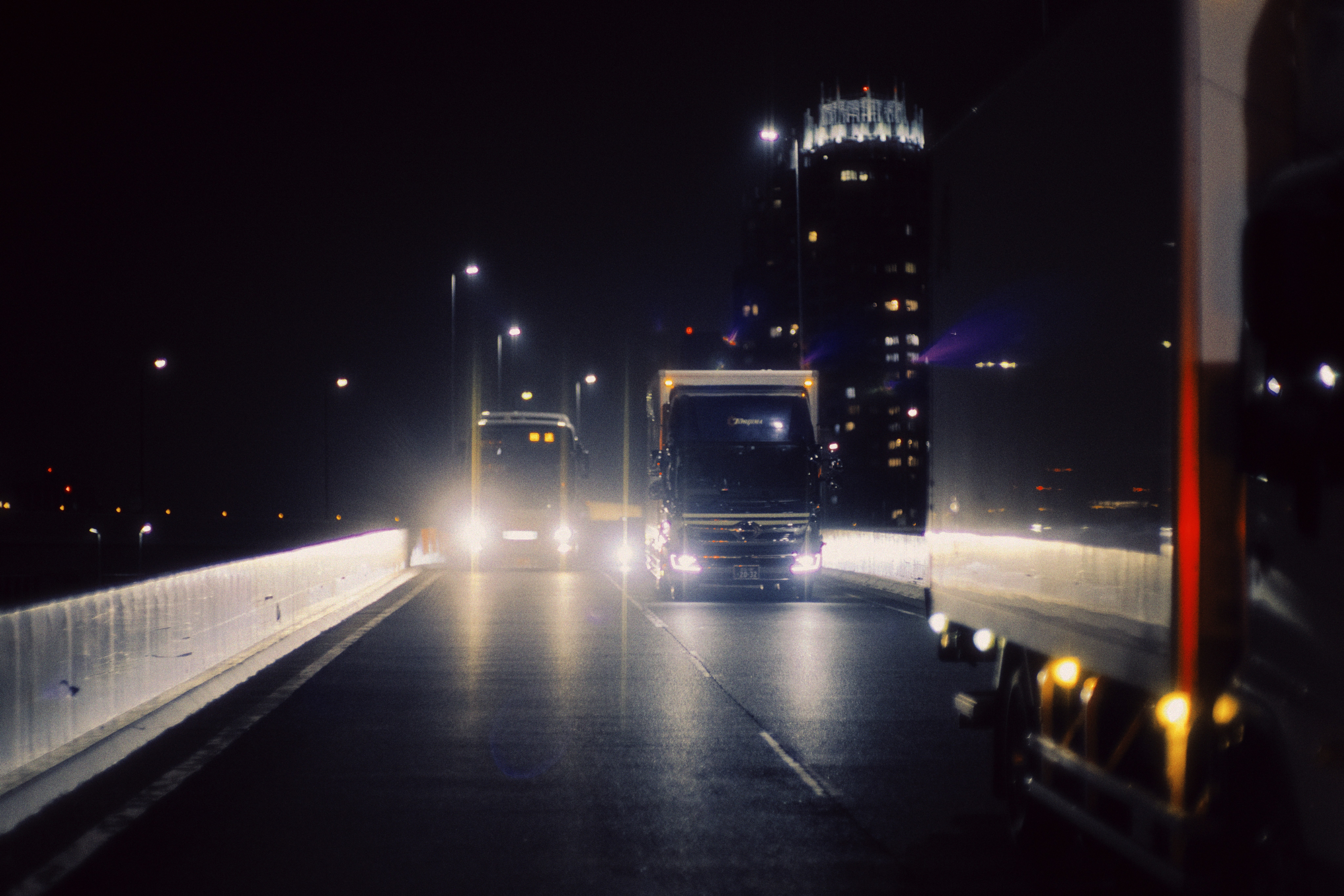 Truck driving on open highway at night
